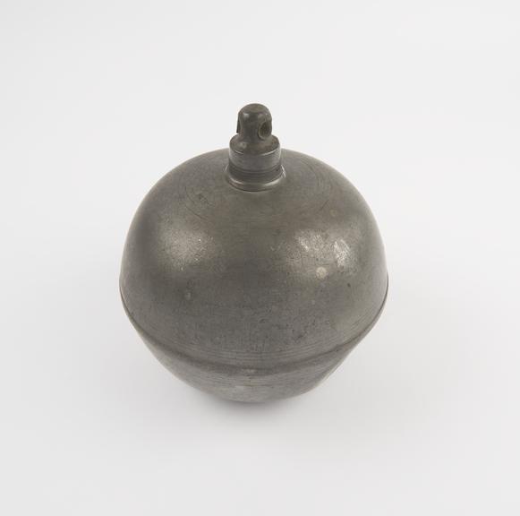 Spherical pewter hot water bottle with projecting screw cap on
