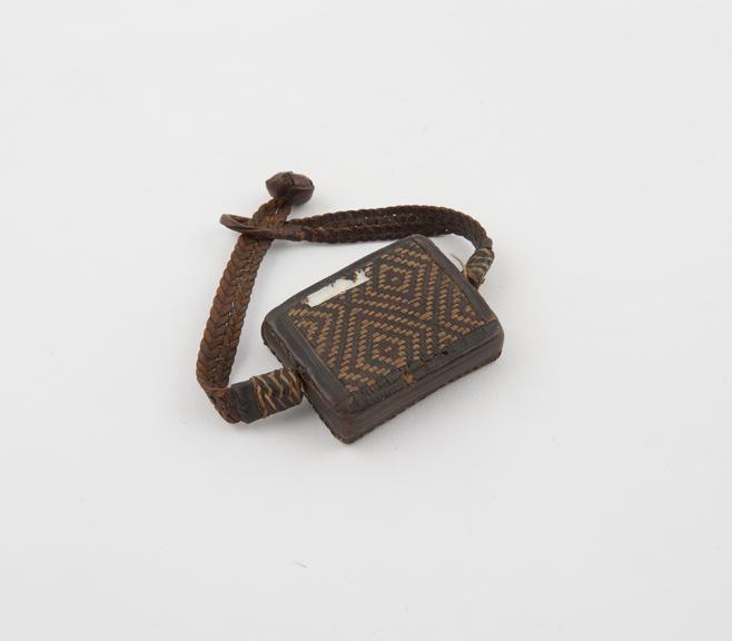 Rectangular amulet with leather straps to form bracelet