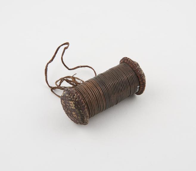 Amulet of wooden sticks bound with copper wire and capped with