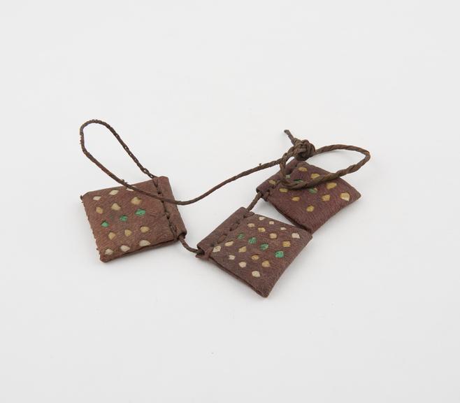 Amuletic necklace consisting of three leather pauches