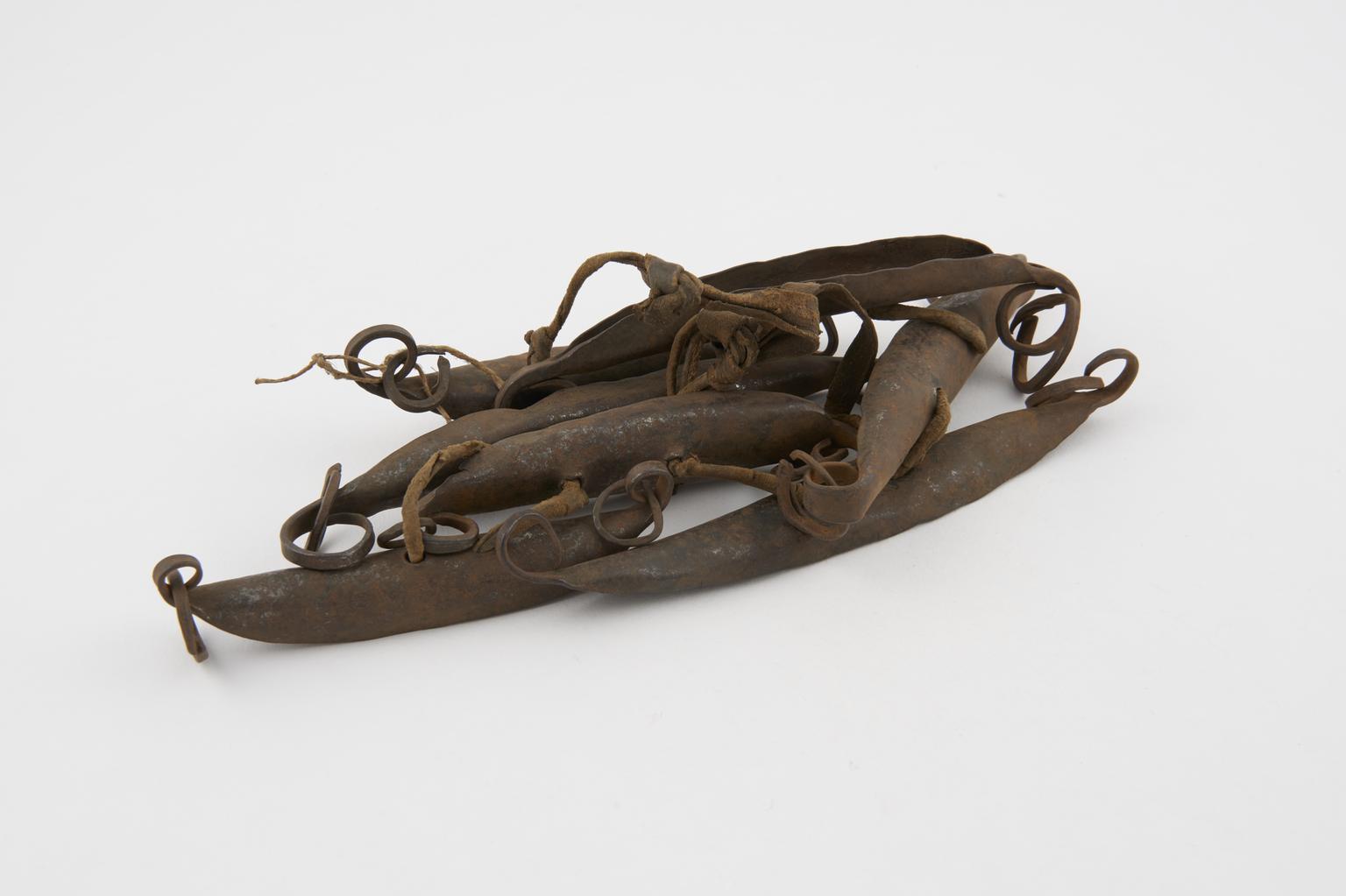 Medicine man's rattle consisting of several iron pod-shaped rattles ...