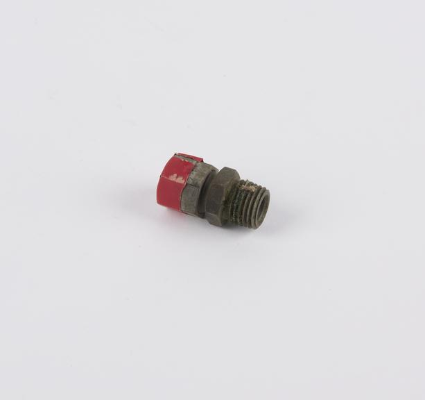 Threaded ?end cap? with red insulating tape affixed at one end