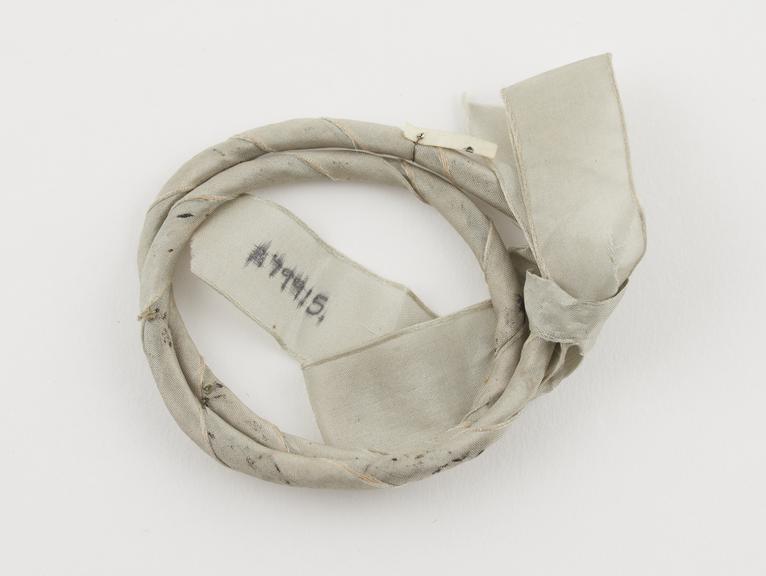 Cramp ring, of thin twigs or wood wrapped in pale blue silk