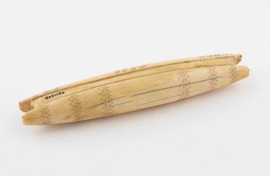 Carved ivory, shuttle-shaped ear lobe distender, Masai