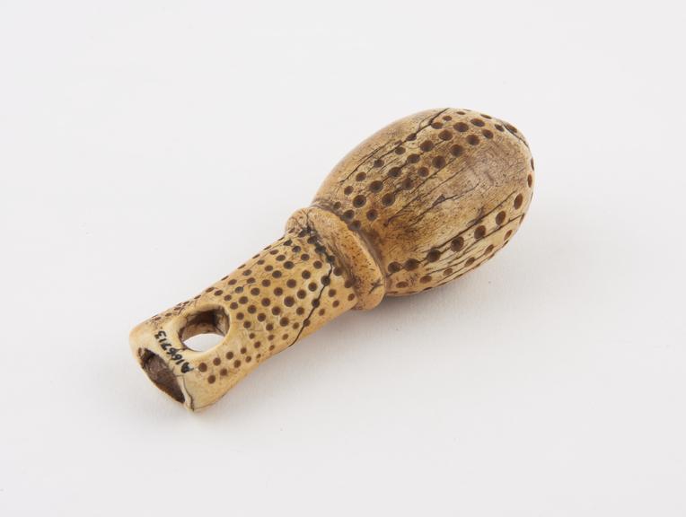 Ivory ear distender, oviform with holes for decoration