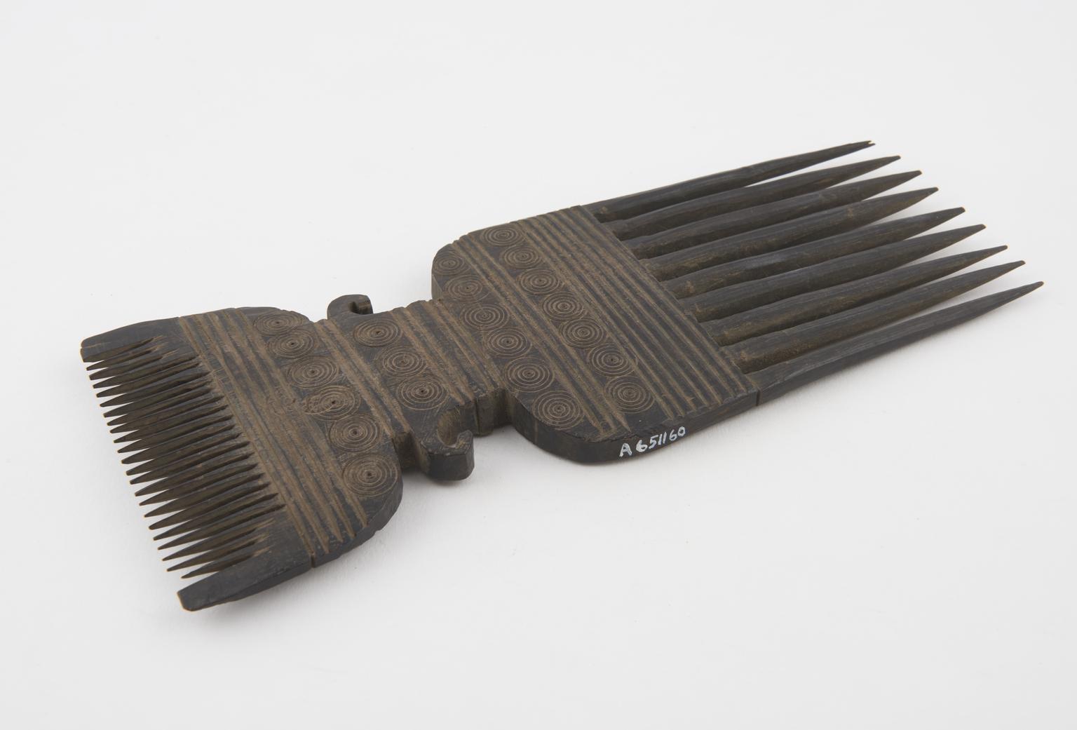 Double-pronged comb decorated with incised circles and lines | Science ...