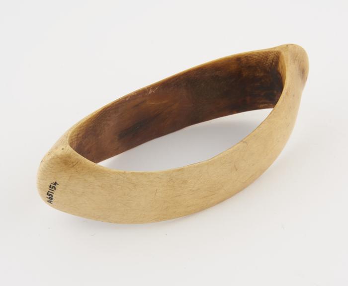 Ivory armlet in the form of a canoe bow, sides curving unwards