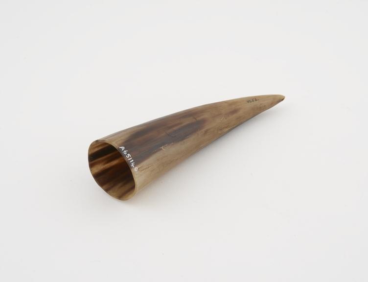 Animal horn with a small hole, a thin slot near tip