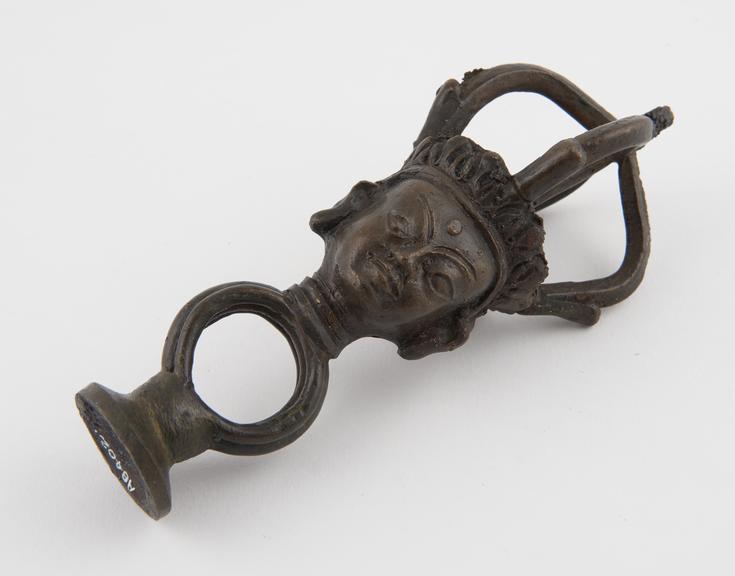 Brass finial(?) consisting of head surmounting by thunderbolt