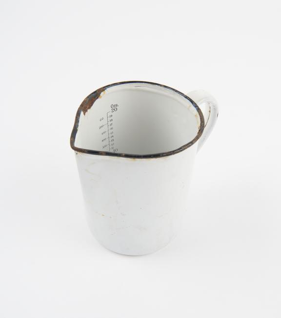 Graduated jug, enamelled iron, corroded, British 1901-1950