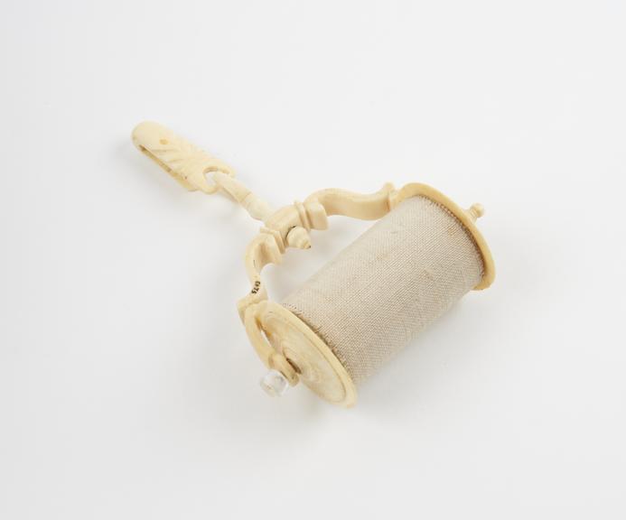 Ivory bandage roller, complete with linen bandage