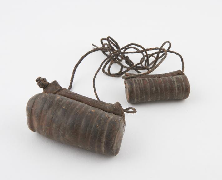 Two leather amuletic cases, cylindrical