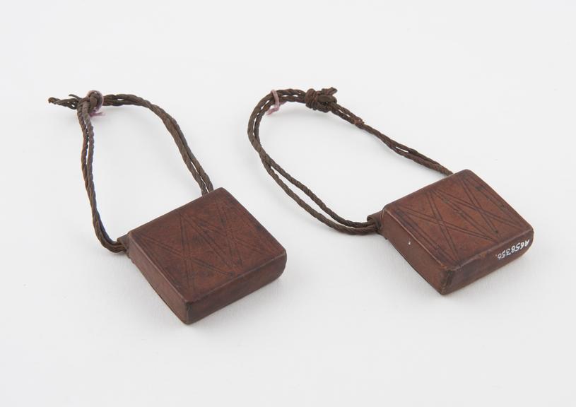 Two identical but separate leather amuletic cases