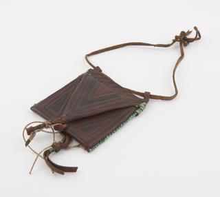 Leather covered cardboard amulet case suspended from thong