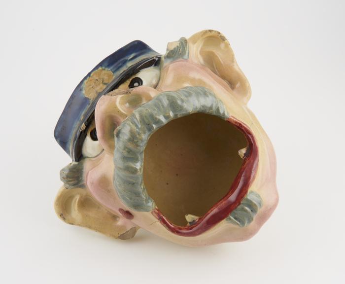 Lead-glazed earthenware spittoon in the form of a face