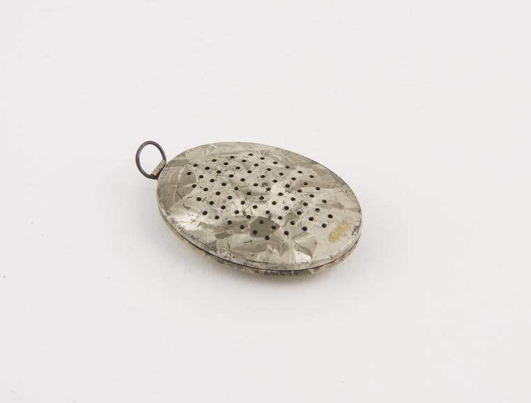 Metal camphor box, flat oval body, perforated with holes