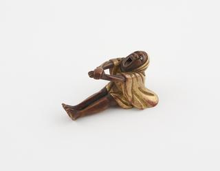 Netsuke in form of seated man grimacing in pain