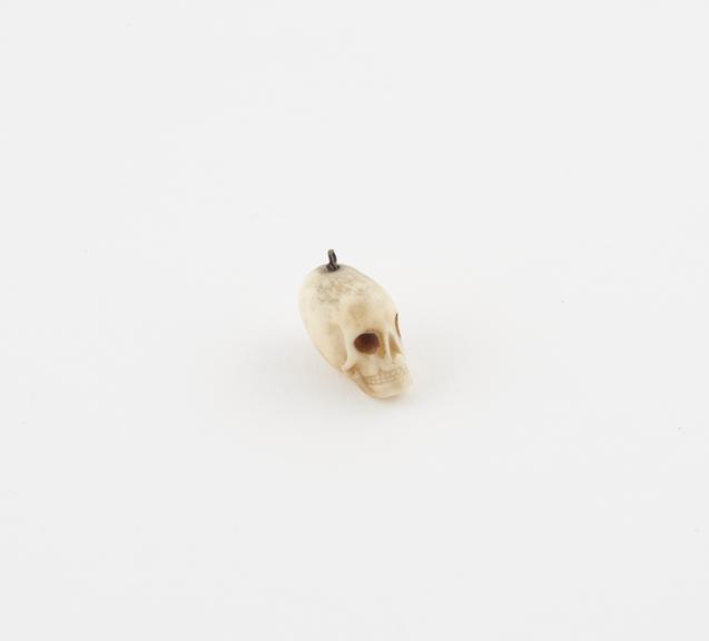 Ivory model of a skull, with loop for suspension