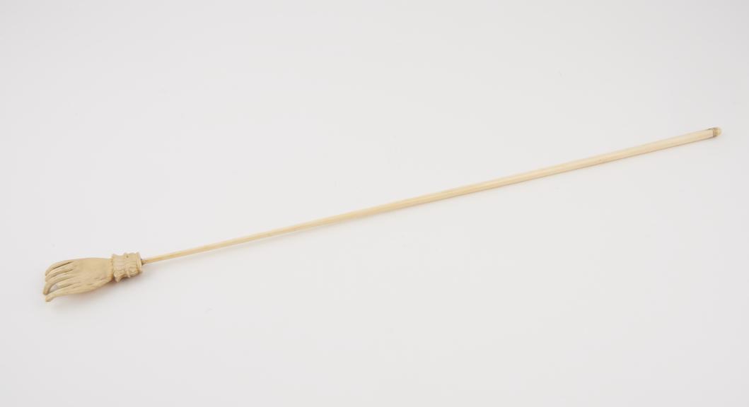 Ivory back scratcher with long cylindrical stem