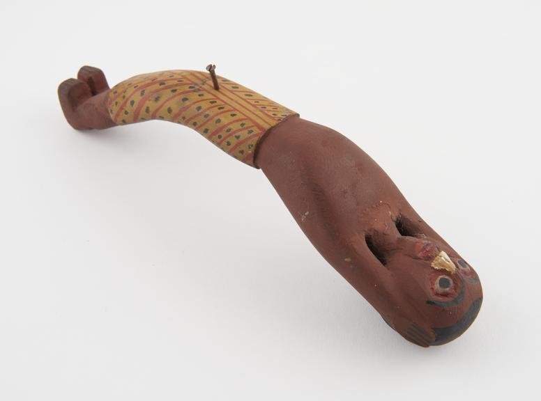 Small carved painted wooden figure of victim from large