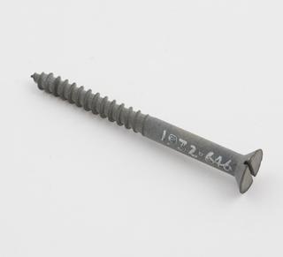 A wood screw illustrating the Sherardizing process.