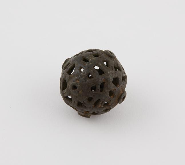 Openwork metal ball containing small piece of metal