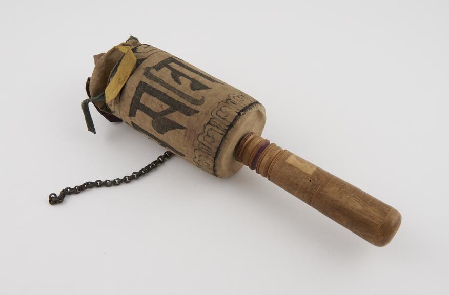 Cloth covered prayer wheel, wooden handle, bronze chain