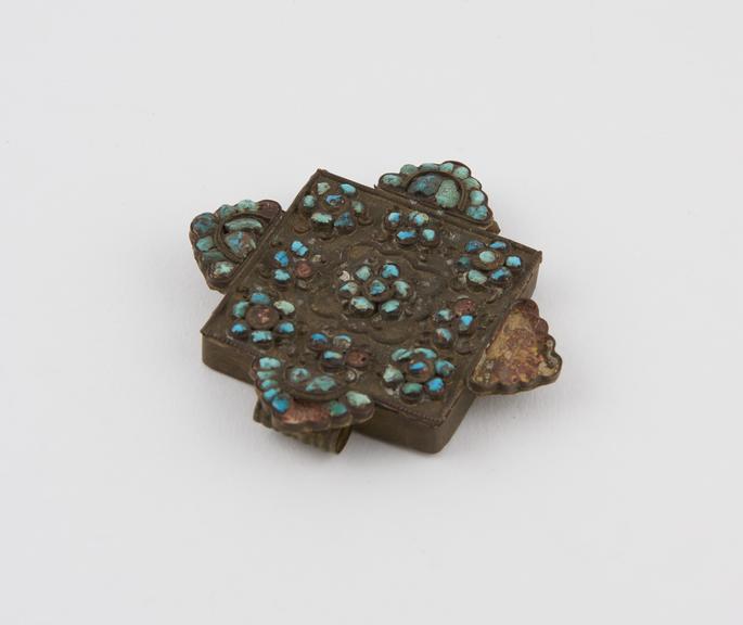 Rectangular amuletic case with turquoise-studded projections