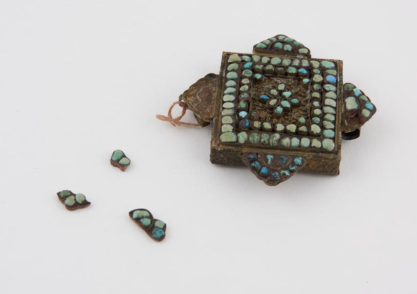 Rectangular amuletic case, with turquoise studded projections