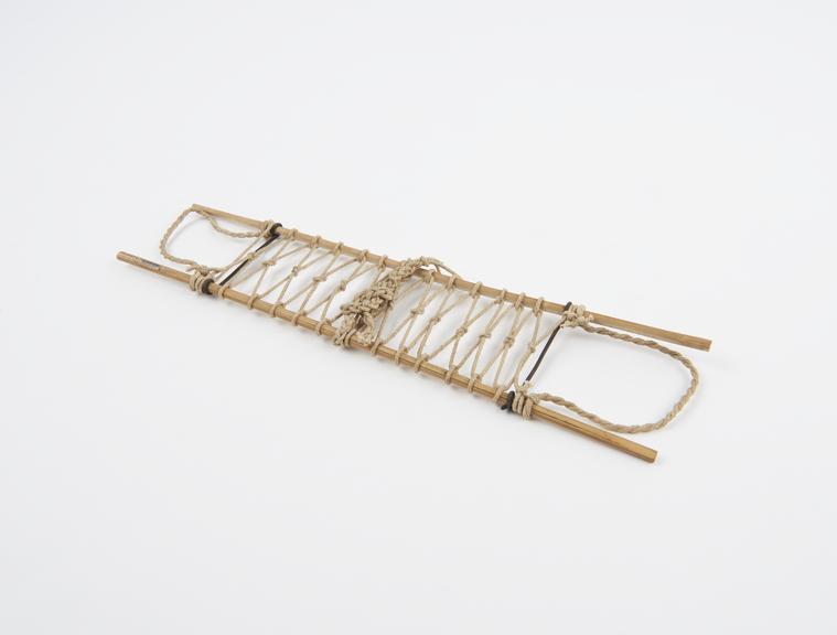 Model of stretcher made with case, metal and string, 1914-1918