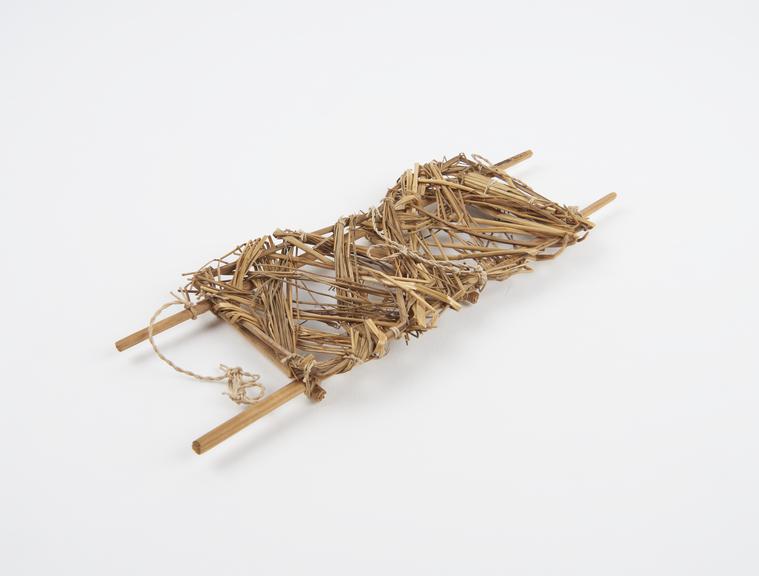 Model of stretcher made with cane, string and dried grass