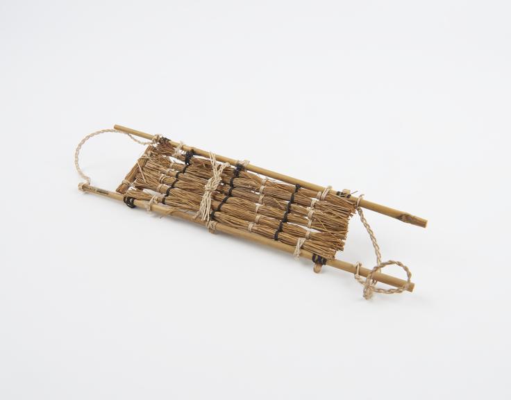 Model of stretcher made with cane, string and dried grass