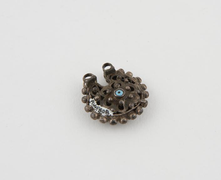 Circular filigree earring with floral design and decorative