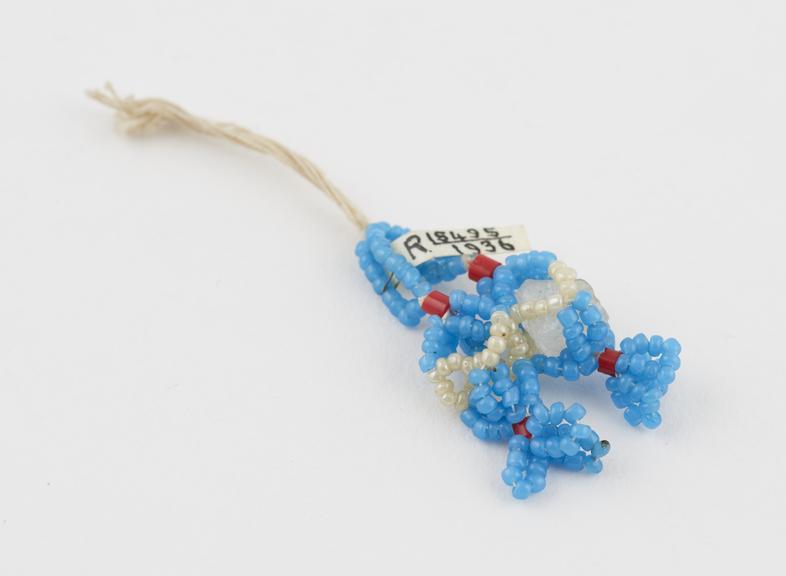 Bead amulet in form of two pieces of alum (one missing)