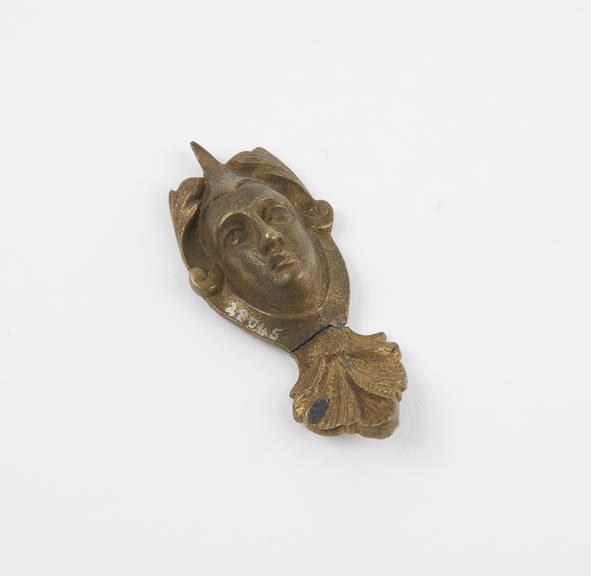 Brass cast of a face