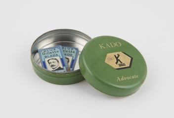 Two 'Blue Gillette' razor blades in circular tin