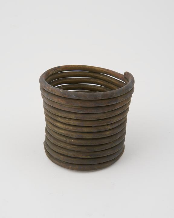 Brass spiral leg ring, from Pekon, Burmese, 1880-1925