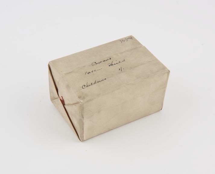 Cowan's vaccination shield, in box in scaled paper envelope