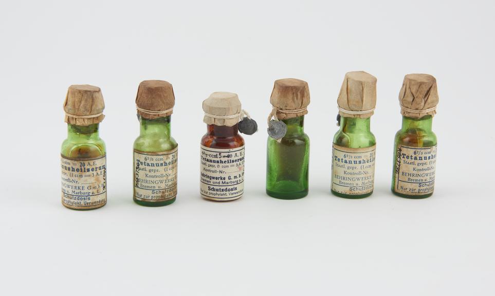 6  bottles, green glass, for tetanus serum, with contents