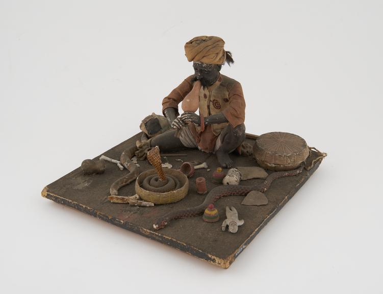 Model figure of snake charmer or fakir