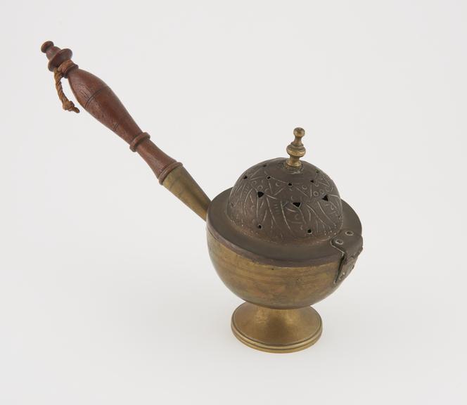 Spherical brass vessel with copper, hinged, lid