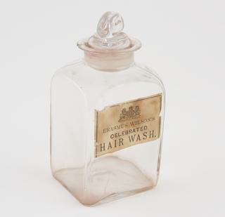 Glass bottle, labelled Erasmus Wilson's celebrated Hair Wash,with royal warrant