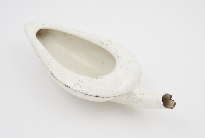 Earthenware, triangular female urinal (spoonbill-shaped)