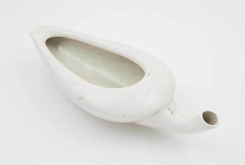 Earthenware, triangular female urinal (spoonbill-shaped)