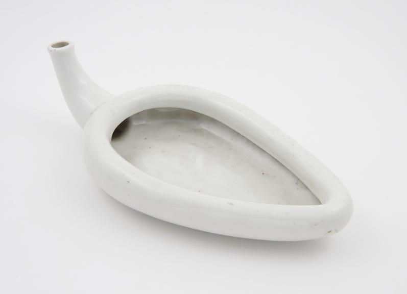 Earthenware, triangular female urinal (spoonbill-shaped)