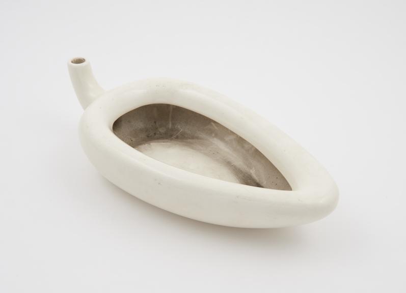 Earthenware, triangular female urinal (spoonbill-shaped)