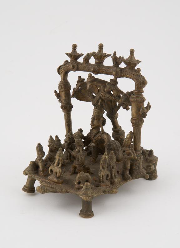 Brass shrine of Krishna as child with accompanying smaller