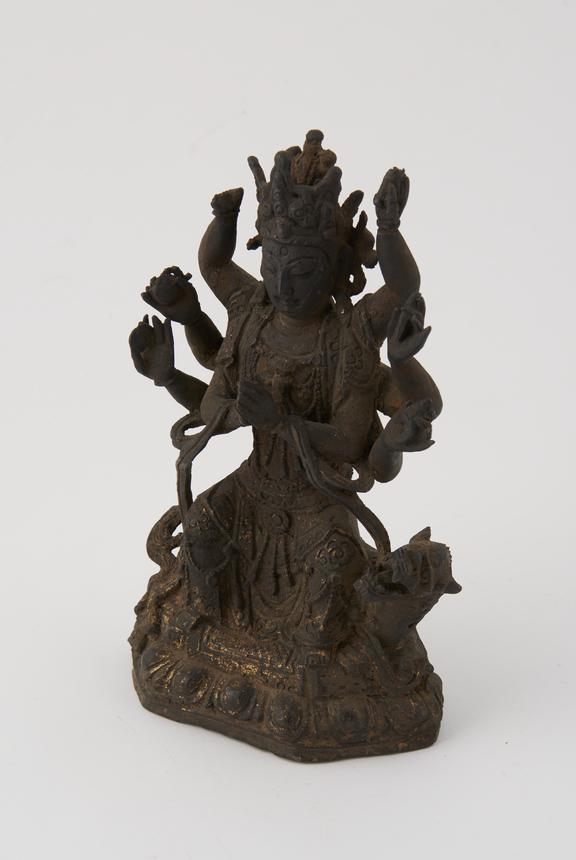 Bronze figure of a male deity seated on a dragon