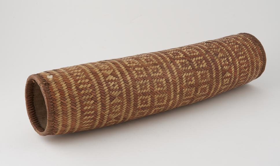 Cylindrical wooden pillow covered with woven raffia in 2