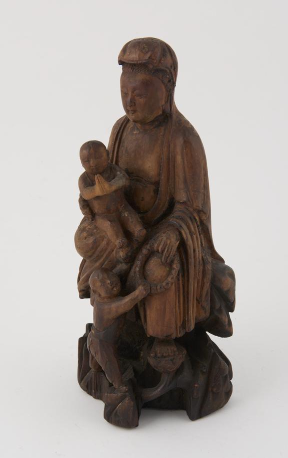 Wooden figure group depicting the goddess Kuan Yin